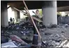  ?? JOHN G. MABANGLO/ AFP VIA GETTY IMAGES ?? Gov. Gavin Newsom removes debris at an encampment along Highway 80 in Berkeley in 2021.