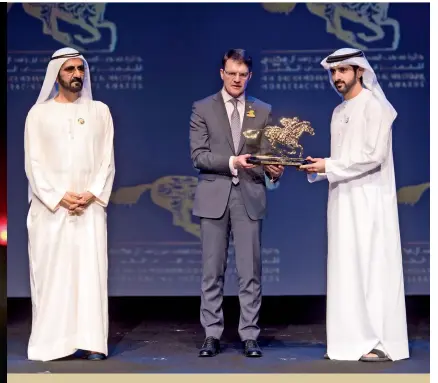  ??  ?? Sheikh Mohammed watches as Sheikh Hamdan bin Mohammed bin Rashid Al Maktoum, Crown Prince of Dubai, presents Aiden O’Brien with his award on Thursday night.