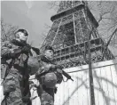  ?? BENOIT TESSIER/REUTERS ?? French soldiers patrol at the Eiffel Tower on Monday in Paris. France raised its terror alert to its highest level following Friday’s shooting in Moscow.