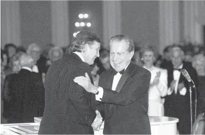  ?? RICHARD CARSON/AP ?? In this March 11, 1989, photo, Donald Trump shakes hands with former President Richard Nixon at a tribute gala to Nellie Connally at the Westin Galleria ballroom in Houston.