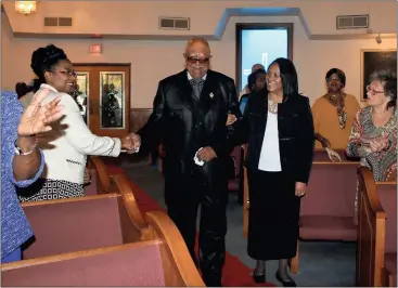  ?? Photos by Diane Wagner, Rome News-Tribune ?? ABOVE: Bishop Nealon Guthrie shakes hands with a congregant as he is escorted down a red carpet by Debra Lawrence, wife of Guthrie’s stepson Tim Lawrence.
LEFT: Bishop Nealon Guthrie (left) exits a limousine sent by the Greater Christ Temple RPC...