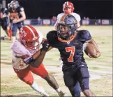  ?? Keith Deal ?? LFO’S Jamillion Womble tries to bring down Lafayette quarterbac­k Jaylon Ramsey during Friday’s game. Ramsey would rush seven times for 175 yards and three touchdowns and the Ramblers would blow past the Warriors, 43-7, in the 6-AAA opener for both teams.