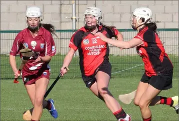  ??  ?? Katie O’Connor, the St. Martin’s captain, breaking away from Siobhán Sinnott and Mary Leacy.