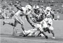  ?? Associated Press ?? ■ Carolina Panthers' Elijah Hood (30) runs past Miami Dolphins' Claudy Mathieu (60) for a touchdown in the second half of a preseason NFL football game Friday in Charlotte, N.C.