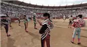  ?? — AFP ?? Spanish matadors gesture to the crowd at the beginning of a bullfight at Plumacon arena during La Madeleine festival, in France, on Wednesday.