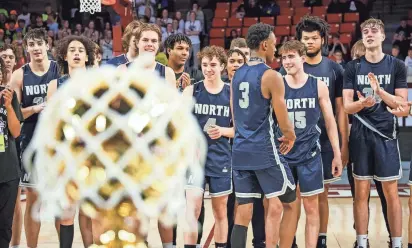  ?? Edmond North players celebrate after beating Broken Arrow in the Class 6A state title game Saturday at Lloyd Noble Center in Norman. NATHAN J. FISH/THE OKLAHOMAN ??