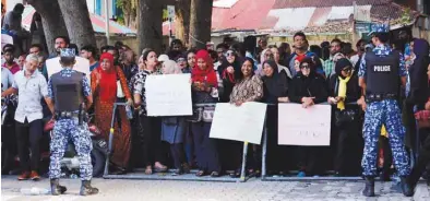  ??  ?? Maldives opposition supporters protest demanding the arrest of defeated President Abdulla Yameen as the Supreme Court began to hear a petition challengin­g the outcome of last’s month election in Male yesterday.