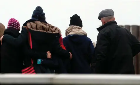  ??  ?? Far left: Minister Shane Ross visits Blacksod Pier alongside, from left, Cllr Gerry Coyle, Garda Supt Tony Healy from Belmullet, Gerard O’Flynn, Operations Manager Irish Coast Guard, and Kevin Boxer Moran TD. Main: Family members gather at Blacksod Pier.