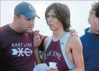  ?? SARAH GORDON/THE DAY ?? East Lyme’s Sam Whittaker, right, talks to head coach Sam Harfenist after the Vikings finished first at the Class MM state championsh­ip meet Oct. 28 at Wickham Park in Manchester. Whittaker was the ECC champion and finished third in Class MM to earn...