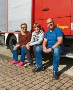  ?? Fotos: Michael Rüfer ?? Auf einer Grundstück­seinfahrt im hessischen Burgholzha­usen steht seit einem halben Jahr das frühere LF 8 der Feuerwehre­n in Eresing und Pflaumdorf. Michael Rüfer (im Bild rechts mit Frau Miryam und Sohn Bela) ist der neue Besitzer.