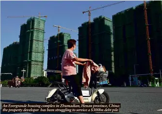  ??  ?? An Evergrande housing complex in Zhumadian, Henan province, China: the property developer has been struggling to service a $300bn debt pile