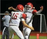  ?? THOMAS NASH - DIGITAL FIRST MEDIA ?? Owen J. Roberts’ Marcus Martin (3) celebrates with quarterbac­k Cooper Chamberlai­n (16) after scoring a touchdown during the fourth quarter of Friday night’s game.