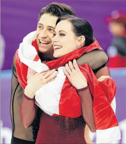  ?? AP PHOTO/DAVID J. PHILLIP ?? Tessa Virtue and Scott Moir of Canada celebrate during the venue ceremony after winning the gold medal in the ice dance, free dance figure skating final in the Gangneung Ice Arena at the 2018 Winter Olympics in Gangneung, South Korea, Tuesday.