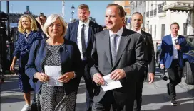 ?? SOREN ANDERSSON / AP ?? Stefan Lofven, leader of the Social Democratic Party and prime minister of Sweden, arrives with his wife, Ulla, to cast his vote in Stockholm, Sweden, on Sunday. “This election is a referendum about our welfare,” Lofven said.