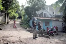  ?? ?? Gendarmes stand guard during a security operation in a shantytown of Koungou on the French Indian Ocean island of Mayotte.