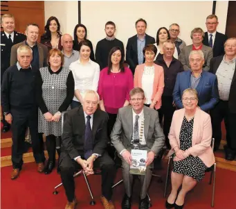  ??  ?? Top: Henry Wymbs signs the distinguis­hed visitors book at County Hall in the presence of his wife, Sally and County Council Chairman, Cllr HubertKean­ey. Above, Henry is joined by family and friends at the reception last Friday evening. ( Left): Henry...