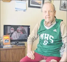  ?? SHARON MONTGOMERY-DUPE/SALTWIRE NETWORK ?? Clyde Harvey, 66, of North Sydney, sits by the television, VCR and phone he received for Christmas from strangers — items which he never owned prior to the holiday season — while proudly wearing a jersey given to him by the Memorial High School boys varsity basketball team. Harvey, originally of Ingonish, had spent Christmas Day alone for the previous 16 years.