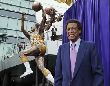  ?? REED SAXON — THE ASSOCIATED PRESS ?? Elgin Baylor stands next to a statue honoring the Minneapoli­s and Los Angeles Lakers great, outside Staples Center in 2018 in Los Angeles.