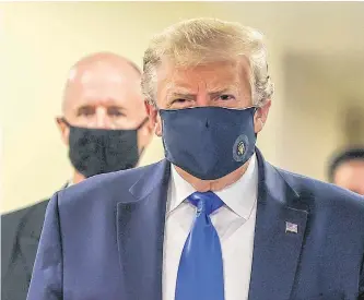  ?? REUTERS • TASOS KATOPODIS ?? U.S. President Donald Trump wore a mask Saturday while visiting Walter Reed National Military Medical Center in Bethesda, Maryland. It was the first time he’s been seen wearing a mask in public.