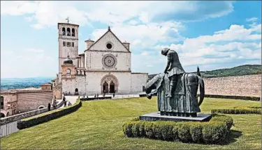  ?? DOMINIC ARIZONA BONUCCELLI/RICK STEVES’ EUROPE ?? The Basilica of St. Francis, built between 1228 and 1253, rises from a ridge at the lower end of Assisi’s old town in Italy. Sleeping: ideale.it). Eating: