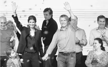  ??  ?? Macri, First Lady Juliana Awada and their daughter Antonia celebrate alongside Vice President Gabriela Michetti (right) Buenos Aires’ City mayor Horacio Rodriguez Larreta (left) and candidate for the Senate Esteban Bullrich (centre, back) at their...