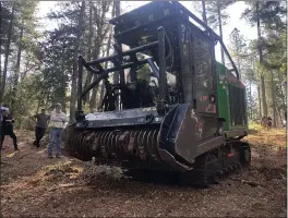  ?? NATALIE HANSON — ENTERPRISE-RECORD ?? Bobcat Chico’s machine for masticatio­n, turning trees to mulch, for fire prevention is demonstrat­ed Friday in Cohasset.