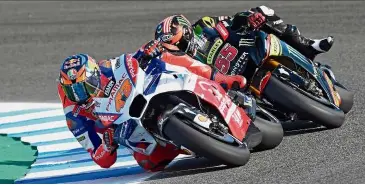  ?? — AFP ?? Riding in pain: Monster Yamaha Tech 3’s Hafizh Syahrin Abdullah (right) gaining on Pramac Ducati’s Jack Miller during the first MotoGP free practice session of the Spanish Grand Prix in Jerez on Friday.