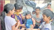  ??  ?? Oneyearold Chahat. who weighs nearly 20kg, with her mother and children of her locality in Amritsar. HT FILE