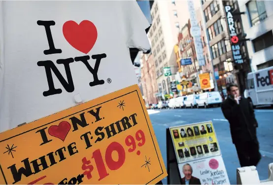  ??  ?? A shirt bearing the “I
NY” logo, designed by Milton Glaser, is displayed at a store in Times Square in New York City. — AFP