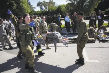  ?? Sebastian Scheiner / Associated Press 2016 ?? Israeli soldiers participat­ed in a drill last year simulating a rocket attack at a base in central Israel.