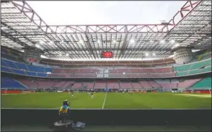  ?? The Associated Press ?? TIME TO RESET: San Siro stadium is devoid of fans during the March 8 Serie A soccer match between AC Milan and Genoa in Milan, Italy. Money that has fueled exorbitant profits — and exorbitant salaries — for most of the current century won't be as easy to find as businesses and entire industries try to recover from the economic shock of the coronaviru­s shutdown.