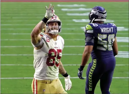  ?? PHOTOS BY RICK SCUTERI — THE ASSOCIATED PRESS ?? 49ers tight end George Kittle signals after a first down as Seattle Seahawks outside linebacker K.J. Wright walks away during the second half on Sunday in Glendale, Ariz.