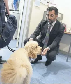  ?? PICTURE: OWEN HUMPHREYS/PA WIRE ?? Humza Yousaf greets Barney, a ‘wellbeing’ dog, during a visit to Moffat Academy yesterday