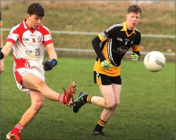  ??  ?? Robert Murphy of Ferns St. Aidan’s takes aim with Adam Fleming (Réalt na Mara) closing in.