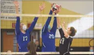  ?? Dave Stewart / Hearst Connecticu­t Media ?? Trumbull’s Ali Castro battles Ludlowe’s Tatum Holderied ( 17) and Caitlin Finnegan ( 20) at the net during the FCIAC East Region girls volleyball final in Trumbull on Saturday.