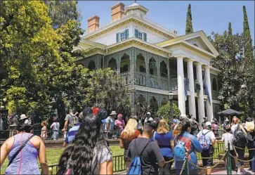  ?? Gary Coronado Los Angeles Times ?? THE CURRENT disability policy primarily affects visitors with cognitive impairment­s such as autism, according to the lawsuits. Above, park visitors wait to get into the Haunted Mansion at Disneyland in 2017.