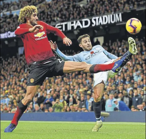  ?? AFP ?? Manchester United midfielder Marouane Fellaini (left) vies with Manchester City's Bernardo Silva at the Etihad Stadium on Sunday.