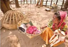  ?? G.N. RAO ?? Gentle lullaby: A baby sleeps in a bamboo cradle woven by his father at Chukkalapa­du settlement of the Muria tribe.