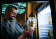  ??  ?? Karl De Smedt (above, with yeast samples) examines one of his library’s starters, #72, from Mexico, which needs to be fed regularly with beer, eggs and lime.