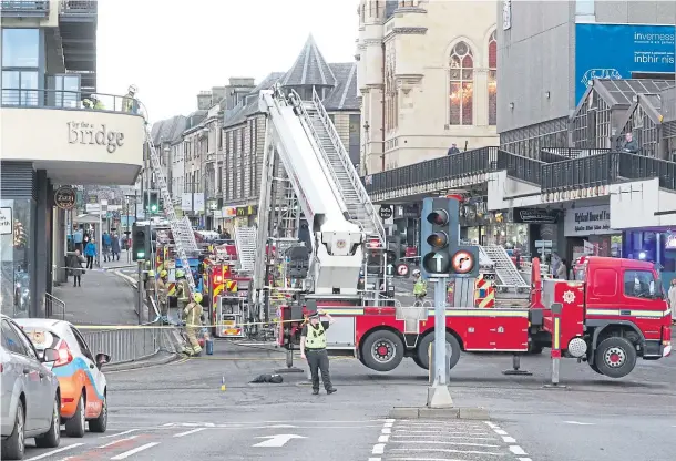  ??  ?? BLAZE SCENE: Bridge Street is sealed off during the morning rush hour as fire crews and police deal with the aftermath of yesterday’s apartments fire