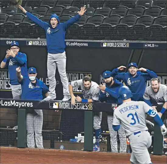  ?? Wally Skalij Los Angeles Times ?? THE DODGERS’ dugout erupts after a solo home run by Joc Pederson in the second inning against the Rays in Game 5 of the World Series on Sunday night.