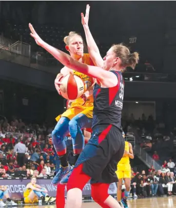  ?? NED DISHMAN/GETTY IMAGES ?? Sky point guard Courtney Vandersloo­t leaves her feet and makes a pass around Mystics forward Emma Messeman on Wednesday in Washington.