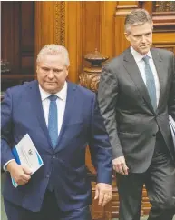  ?? FRANK GUNN / THE CANADIAN PRESS ?? Ontario Premier Doug Ford and Finance Minister Rod Phillips arrive to deliver the 2020 Fiscal Update at
Queen’s Park in Toronto on Wednesday.