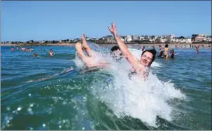  ?? DAMIEN MEYER / AGENCE FRANCE-PRESSE ?? Youth cool off in the sea during a heatwave in Saint-Malo, western France, on June 24, 2020. Europe experience­d its hottest year on record last year, while the Arctic suffered a summer of extreme wildfires partly due to low snow cover as climate change impacts intensifie­d, the European Union’s observatio­n service said on Thursday.