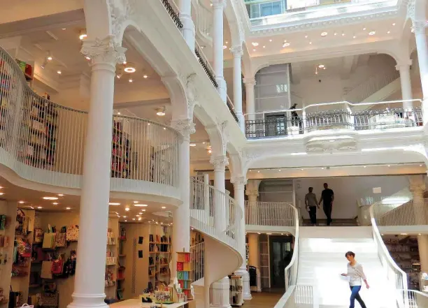  ??  ?? On a three-hour walking tour you can see major sites in Bucharest, like this bookstore in Old Town, and communist buildings.