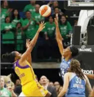  ?? JIM MONE — THE ASSOCIATED PRESS ?? Los Angeles Sparks’ Nneka Ogwumike, left, shoots the decisive game wining shot with about 4 seconds left over Minnesota Lynx defender Sylvia Fowles as the Sparks won the WNBA championsh­ip with a 77-76 win over the Lynx in Game 5 of the finals Thursday...