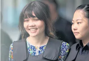  ?? AP ?? Vietnamese Doan Thi Huong, left, is escorted by police as she leaves Shah Alam court house ion Wednesday.