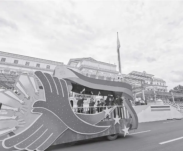  ?? NONIE REYES ?? A FLOAT carrying children symbolizin­g the future generation passes by the National Museum in Manila as preparatio­ns go into full swing for the inaugurati­on ceremony of Ferdinand “Bongbong” Romualdez Marcos Jr. at noon of Thursday, June 30, 2022, as the 17th President of the Republic.