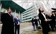  ?? AP PHOTO BY ELAINE THOMPSON ?? Mariko Hirose, right, a litigation director at the Urban Justice Center, addresses reporters as Mark Hetfield, president & CEO of HIAS, left, and Rabbi Will Berkowitz, Jewish Family Service of Seattle CEO, look on in front of a federal courthouse after...