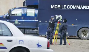  ?? DESMOND MURRAY/THE CANADIAN PRESS ?? Police set up laser survey equipment while searching a farm near Salmon Arm, on Monday. Police say human remains have been discovered on a rural property north of Vernon.